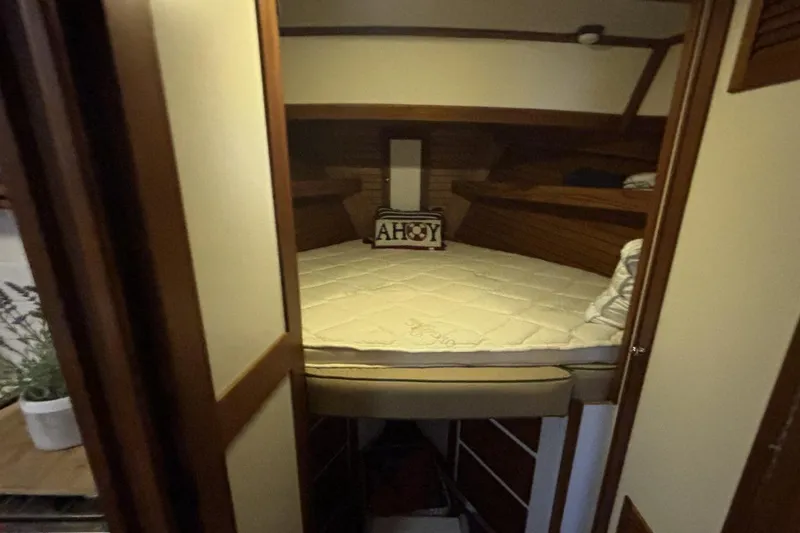 Slide: The Image of Cozy cabin interior of 1987 Wilbur 38 boat with "Ahoy" pillow on bed. - 25