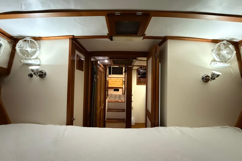 Slide: The Image of Interior of 1987 Wilbur 38 boat, featuring wood accents and cozy cabin layout. - 27