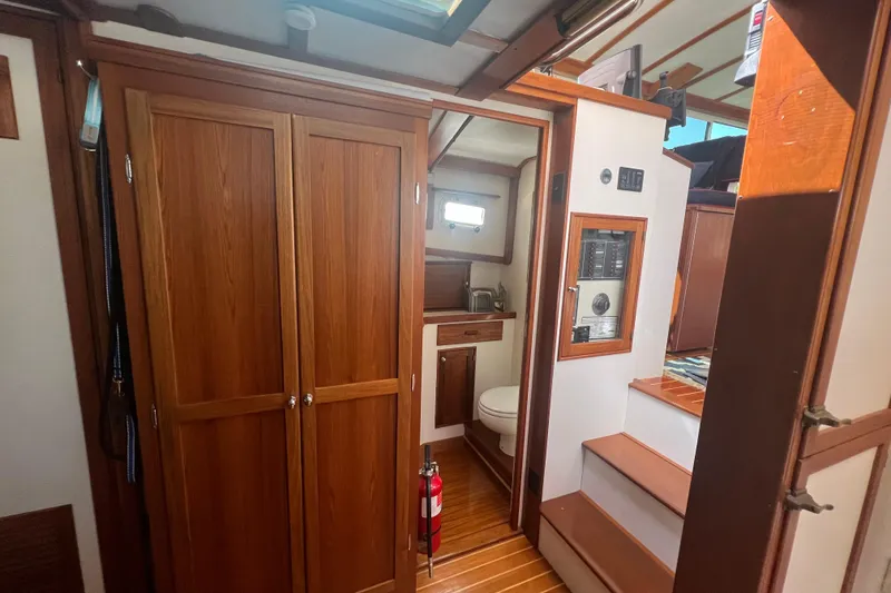 Slide: The Image of Interior of 1987 Wilbur 38 boat with wooden cabinetry and compact bathroom. - 28