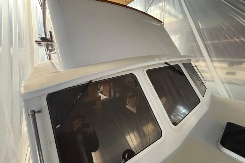 Slide: The Image of 1987 Wilbur 38 boat cabin with large windows and sleek design. - 32