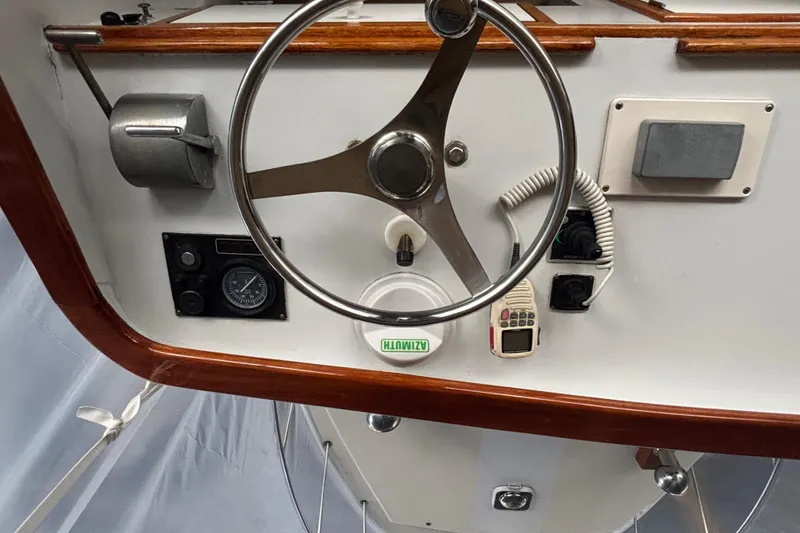 Slide: The Image of Steering wheel and controls of a 1987 Wilbur 38 boat cockpit. - 37