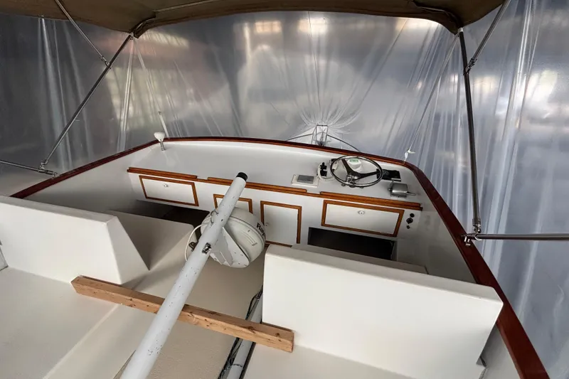 Slide: The Image of Interior view of a 1987 Wilbur 38 boat cockpit with steering wheel and controls. - 38