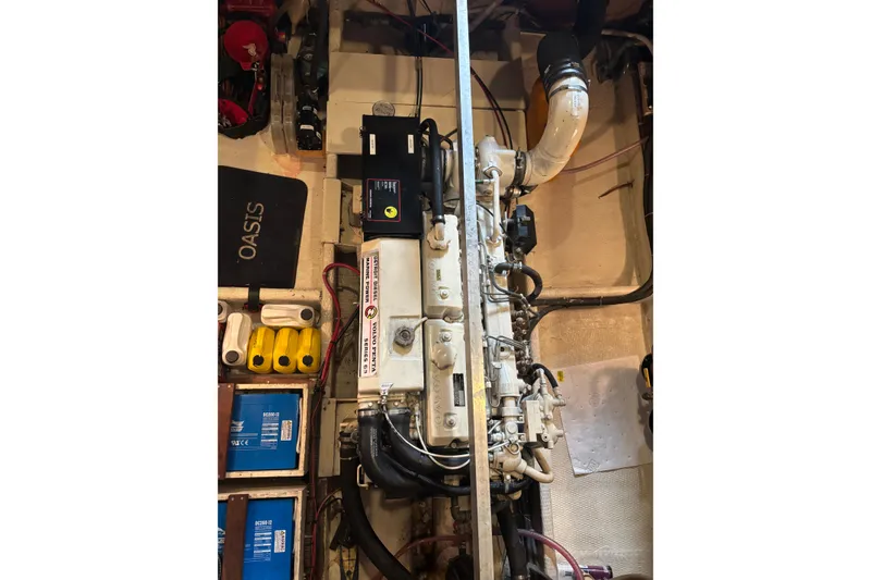 Slide: The Image of Engine room of a 1987 Wilbur 38 boat, showcasing mechanical components and wiring. - 39