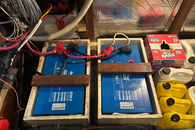 Slide: The Image of Battery setup in a 1987 Wilbur 38 boat, featuring wiring and storage compartments. - 41