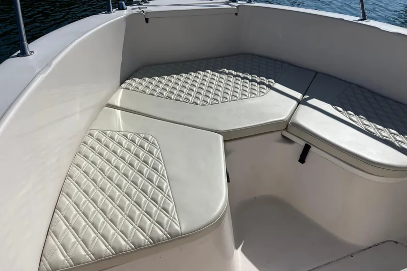 Slide: The Image of 1999 Grady-White Escape 209 boat interior with cushioned seating and diamond pattern design. - 11