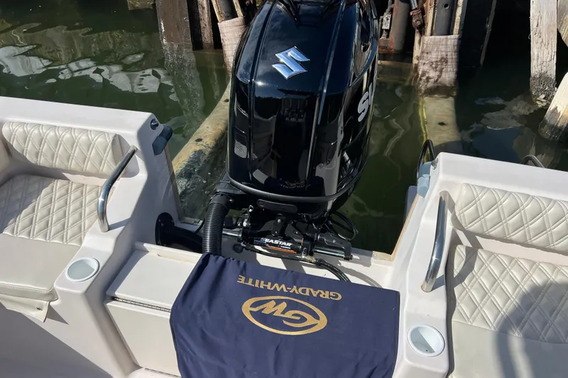 Slide: The Image of 1999 Grady-White Escape 209 boat with Suzuki outboard motor and cushioned seating. - 17