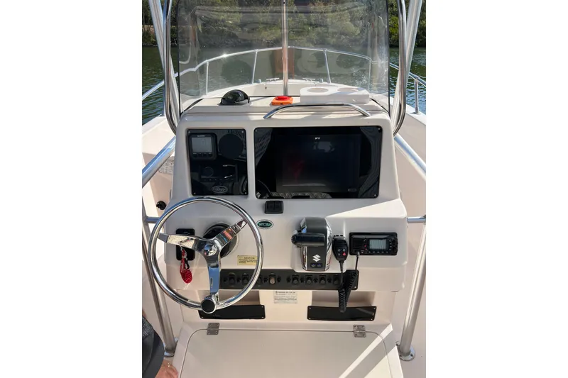 Slide: The Image of 1999 Grady-White Escape 209 boat dashboard with steering wheel and navigation equipment. - 21