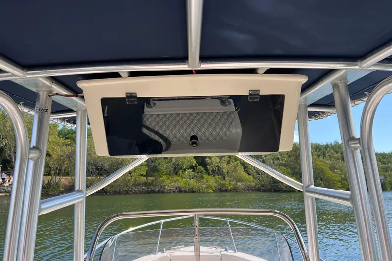 Slide: The Image of 1999 Grady-White Escape 209 boat with canopy, cruising on a scenic river. - 22