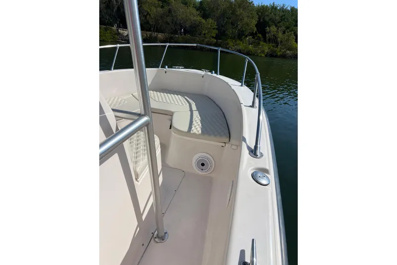 Slide: The Image of 1999 Grady-White Escape 209 boat interior with cushioned seating and railing. - 24