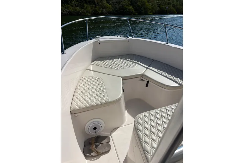 Slide: The Image of 1999 Grady-White Escape 209 boat interior with cushioned seating and scenic water view. - 25