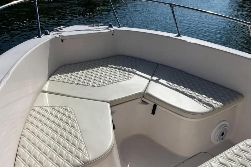 Slide: The Image of 1999 Grady-White Escape 209 boat interior with cushioned seating and water view. - 27