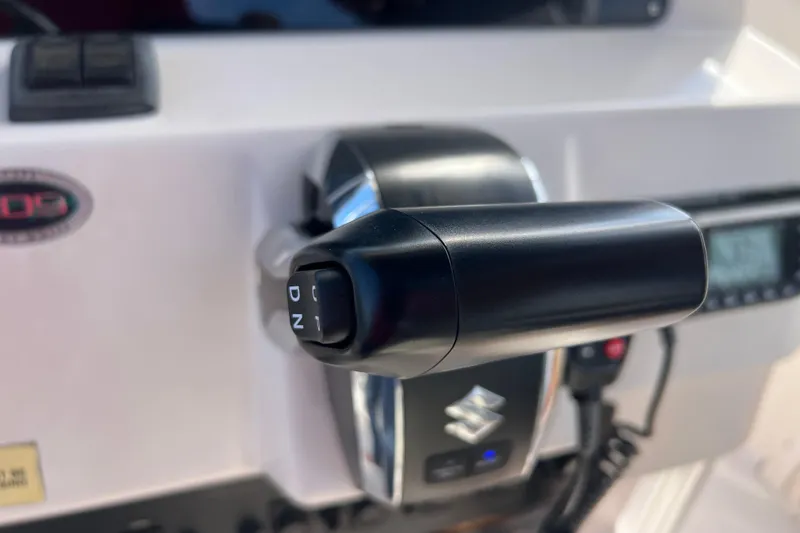 Slide: The Image of Close-up of a 1999 Grady-White Escape 209 boat throttle control. - 33