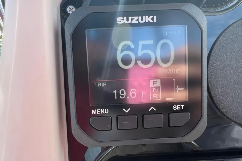 Slide: The Image of Suzuki display showing 650 RPM and 19.6 hours on Grady-White Escape 209 boat. - 35