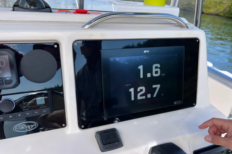 Slide: The Image of 1999 Grady-White Escape 209 boat dashboard with speed and depth display. - 37