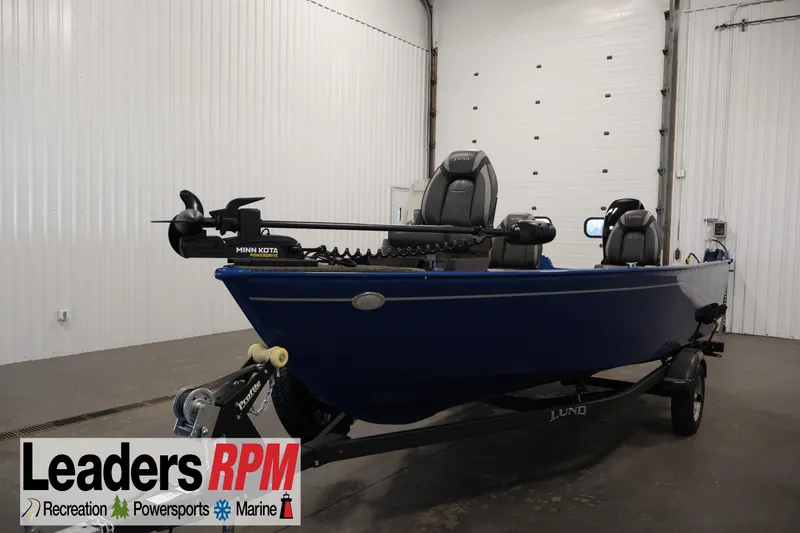 The Image of 2021 Lund 1650 Angler Sport boat in showroom, featuring Minn Kota trolling motor. - 1