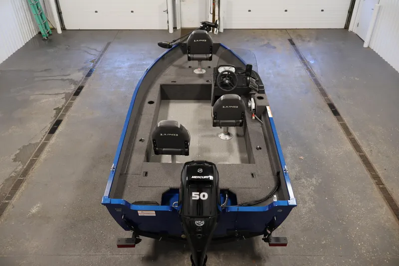 Slide: The Image of 2021 Lund 1650 Angler Sport boat with Mercury 50 engine in a garage setting. - 10