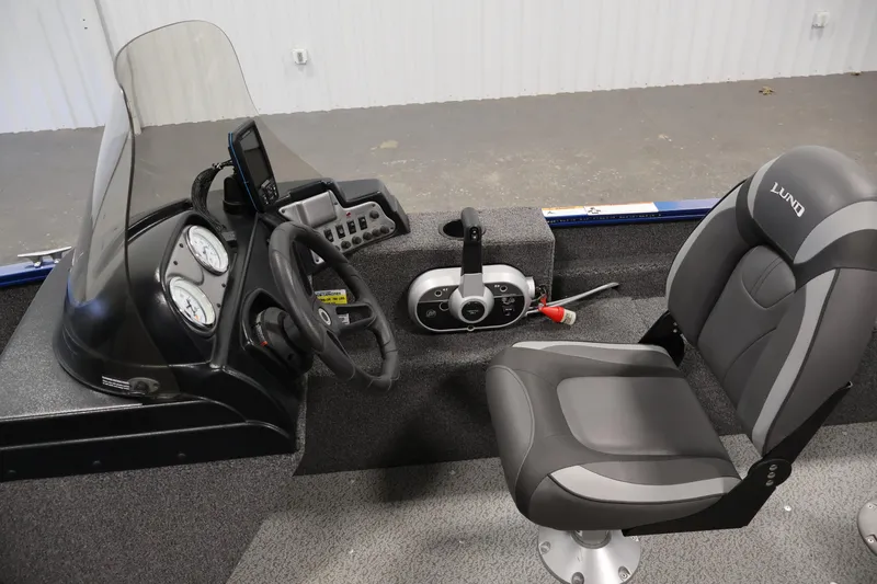 Slide: The Image of 2021 Lund 1650 Angler Sport boat interior with steering console and seat. - 16