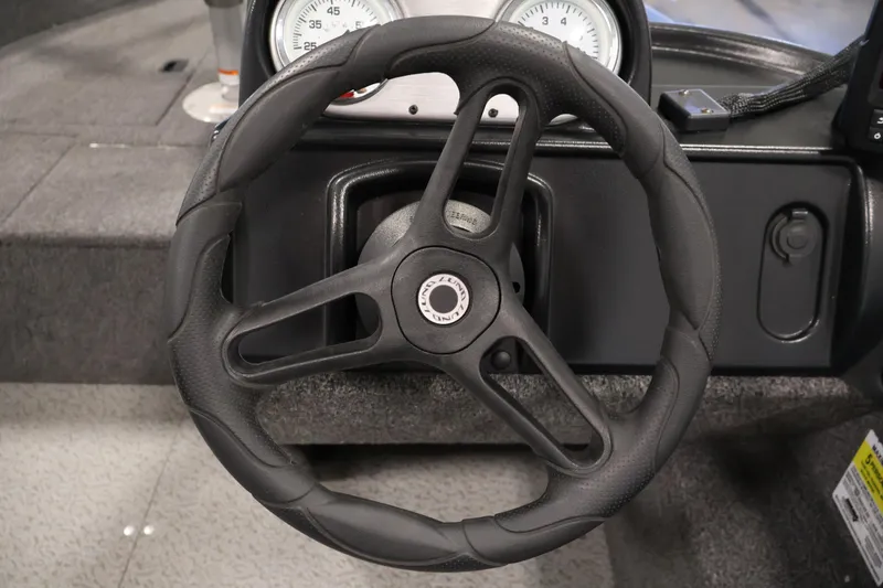 Slide: The Image of Steering wheel of 2021 Lund 1650 Angler Sport boat, featuring a sleek black design. - 18