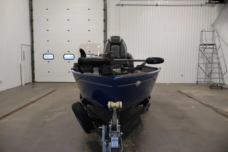 Slide: The Image of 2021 Lund 1650 Angler Sport boat in a garage, front view. - 2