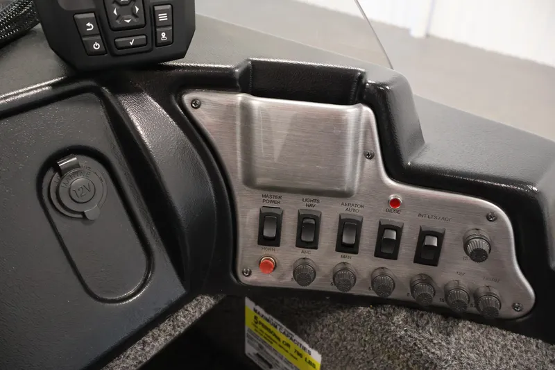 Slide: The Image of Control panel of 2021 Lund 1650 Angler Sport boat with switches and 12V outlet. - 21