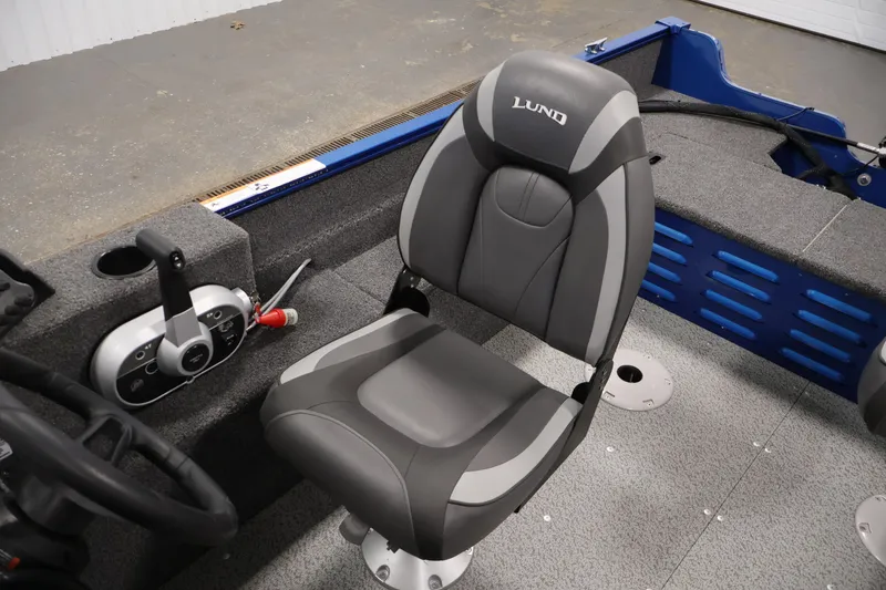 Slide: The Image of 2021 Lund 1650 Angler Sport boat interior with gray seat and control panel. - 22