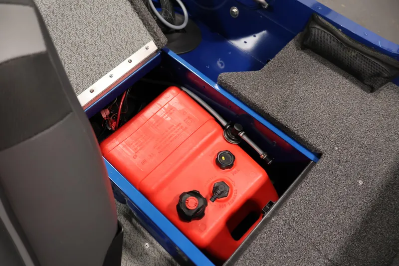 Slide: The Image of 2021 Lund 1650 Angler Sport boat with red fuel tank under carpeted storage. - 24