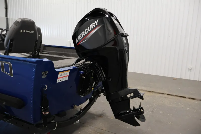 Slide: The Image of 2021 Lund 1650 Angler Sport boat with Mercury outboard motor in a garage. - 25