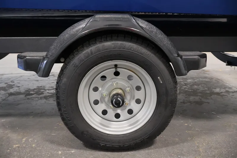 Slide: The Image of Trailer wheel of 2021 Lund 1650 Angler Sport boat, featuring radial tire and fender. - 32