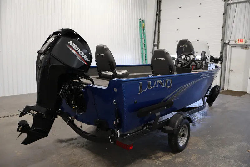 Slide: The Image of 2021 Lund 1650 Angler Sport boat with Mercury engine in a garage setting. - 5