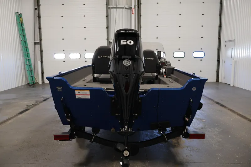 Slide: The Image of 2021 Lund 1650 Angler Sport boat with 50 HP motor in a garage setting. - 6