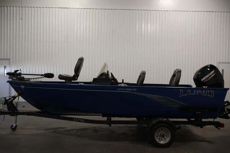 Slide: The Image of 2021 Lund 1650 Angler Sport boat with Mercury engine, displayed indoors. - 8