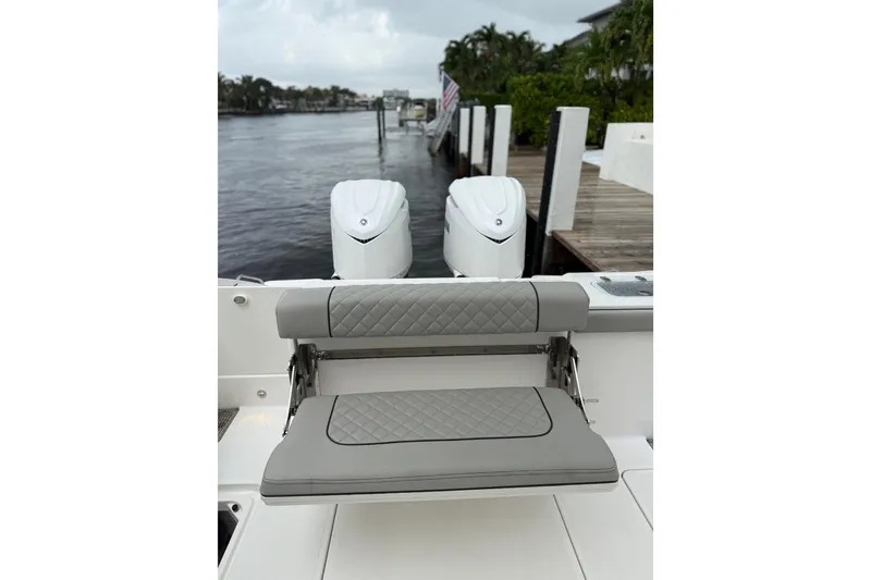 Slide: The Image of 2025 Pursuit OS 325 Offshore boat with dual engines and cushioned seating. - 15