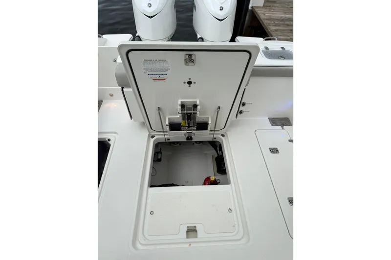 Slide: The Image of 2025 Pursuit OS 325 Offshore boat with open hatch revealing storage compartment. - 20