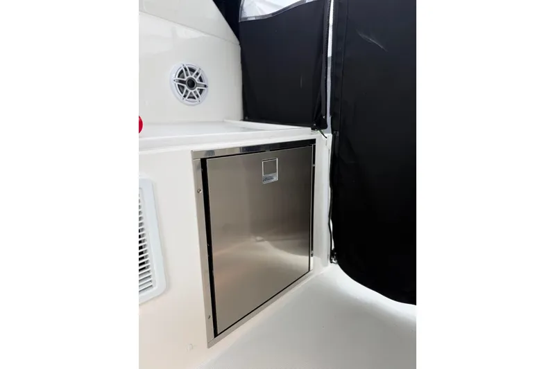 Slide: The Image of 2025 Pursuit OS 325 Offshore boat interior with stainless steel storage compartment. - 32