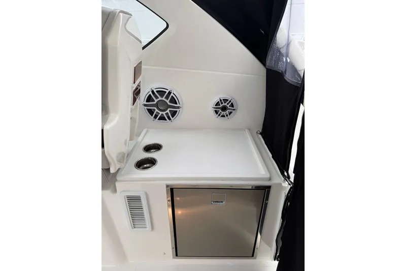 Slide: The Image of Interior of 2025 Pursuit OS 325 Offshore boat with speakers and compact fridge. - 33
