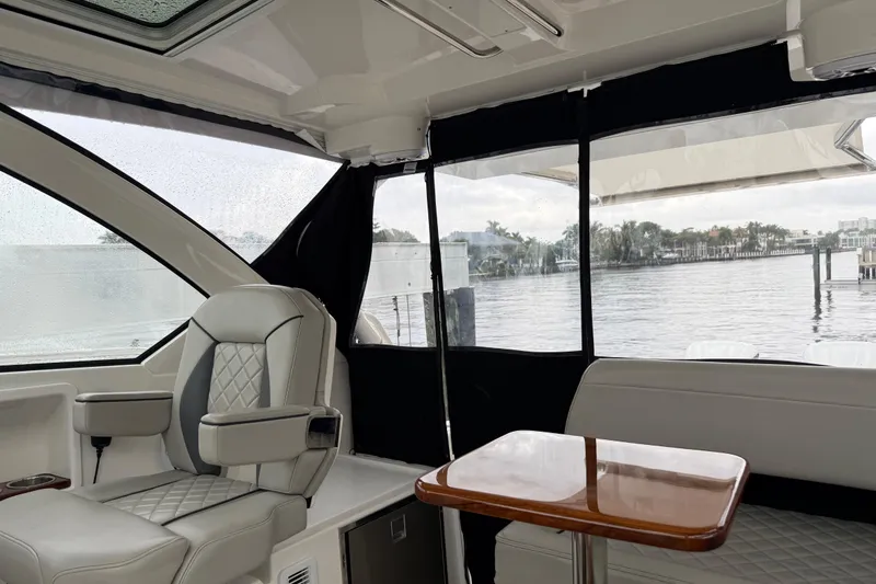 Slide: The Image of Interior of 2025 Pursuit OS 325 Offshore boat with luxurious seating and waterfront view. - 34
