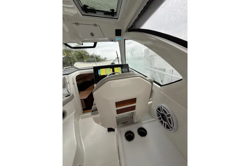 Slide: The Image of 2025 Pursuit OS 325 Offshore boat interior with modern dashboard and navigation screens. - 52
