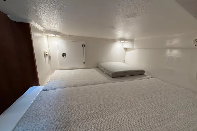 Slide: The Image of 2025 Pursuit OS 325 Offshore cabin interior with cozy sleeping area. - 65