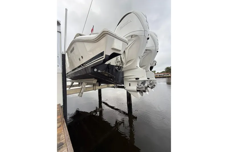 Slide: The Image of 2025 Pursuit OS 325 Offshore boat with dual Yamaha engines on a lift. - 7