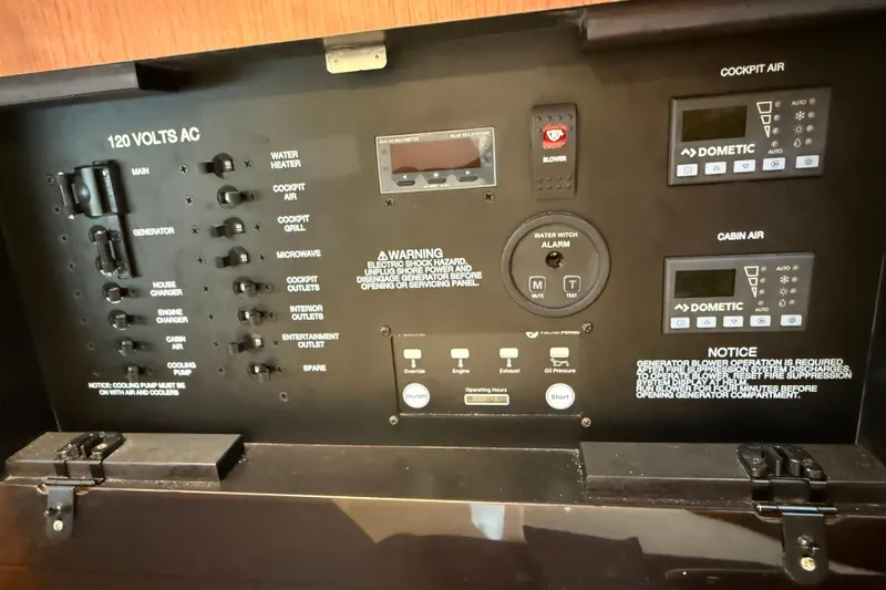 Slide: The Image of Control panel of 2025 Pursuit OS 325 Offshore boat, featuring various switches and displays. - 72
