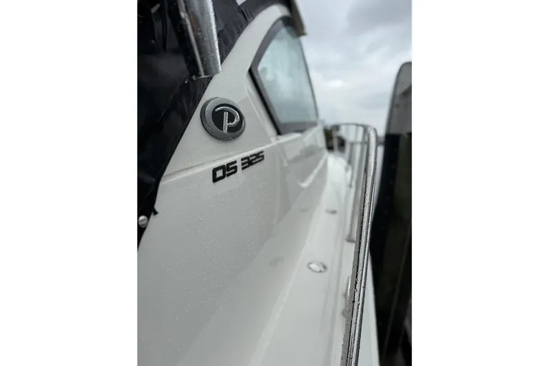Slide: The Image of 2025 Pursuit OS 325 Offshore boat side view with logo and railing. - 86