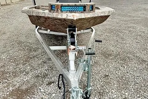 Slide: The Image of 2026 Xpress X18DB boat on trailer, gravel background, front view. - 4