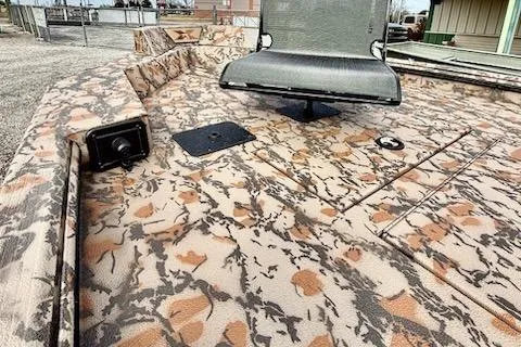 Slide: The Image of 2026 Xpress X18DB boat with camouflage deck and swivel seat. - 6