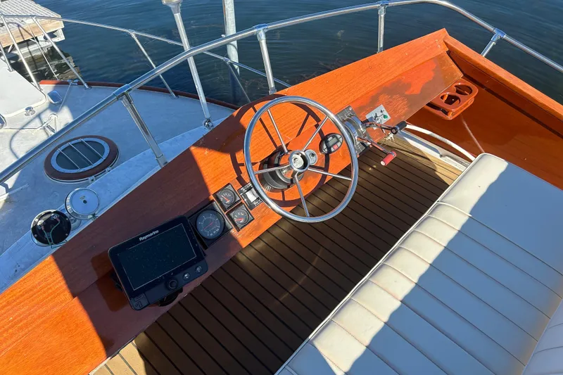 Slide: The Image of 1986 Skiff Craft Sport Fisherman boat helm with wooden dashboard and steering wheel. - 4