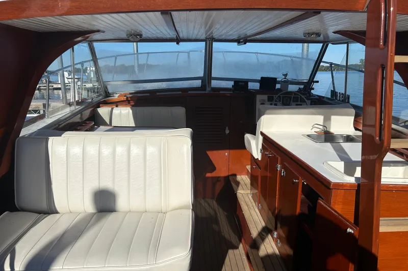 Slide: The Image of 1986 Skiff Craft Sport Fisherman interior with white seating and wooden cabinetry. - 5