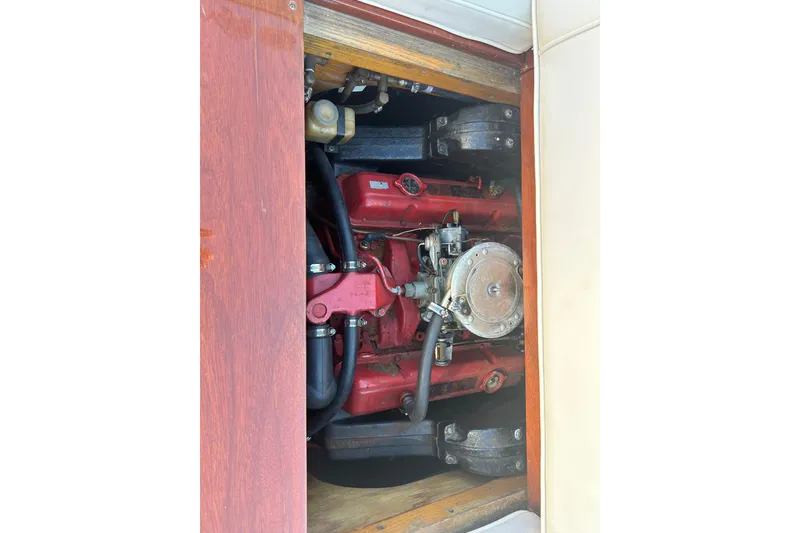 Slide: The Image of Engine compartment of a 1986 Skiff Craft Sport Fisherman boat, showcasing red engine components. - 6