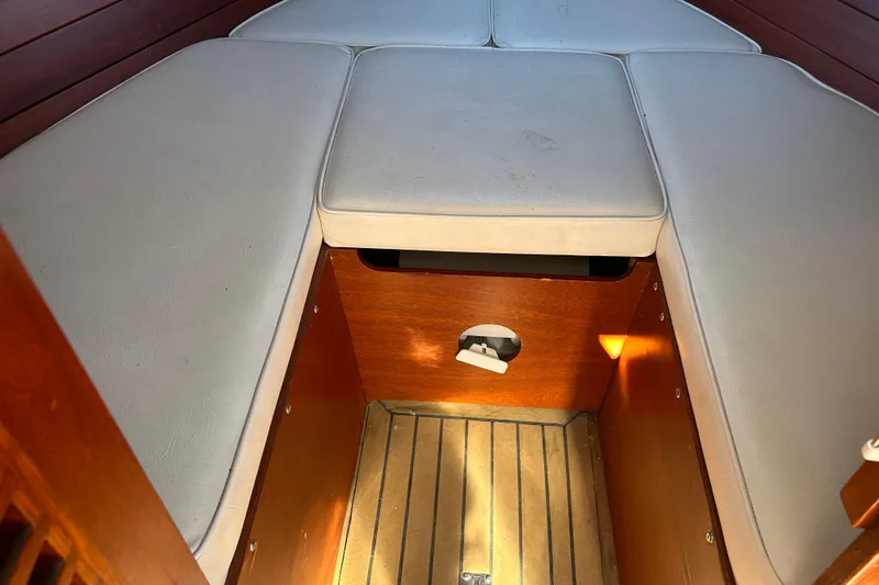 Slide: The Image of 1986 Skiff Craft Sport Fisherman interior with cushioned seating and wooden flooring. - 8