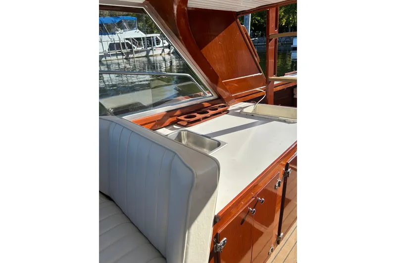 Slide: The Image of 1986 Skiff Craft Sport Fisherman boat interior with sink and wooden cabinetry. - 9