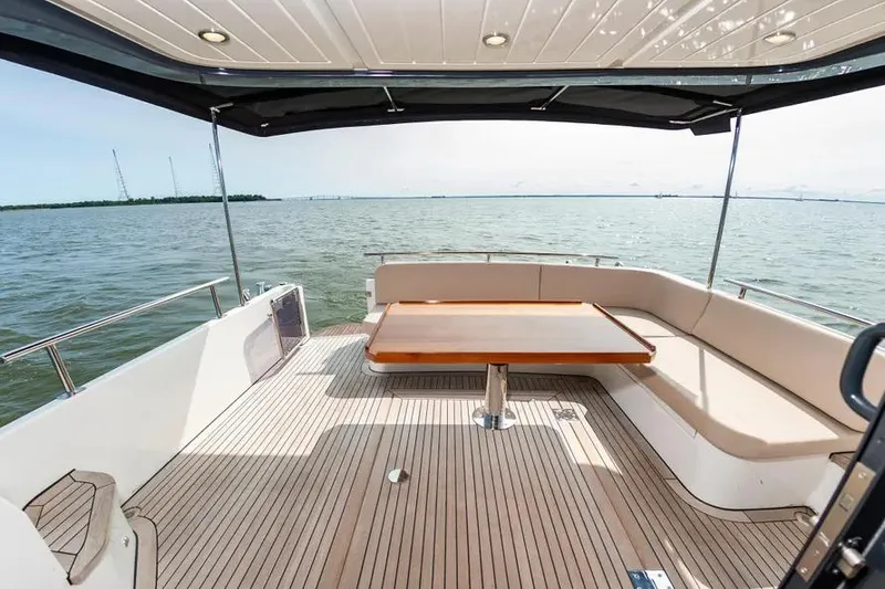 Slide: The Image of Luxurious 2023 Pescador 35 yacht deck with seating and table, overlooking serene waters. - 10
