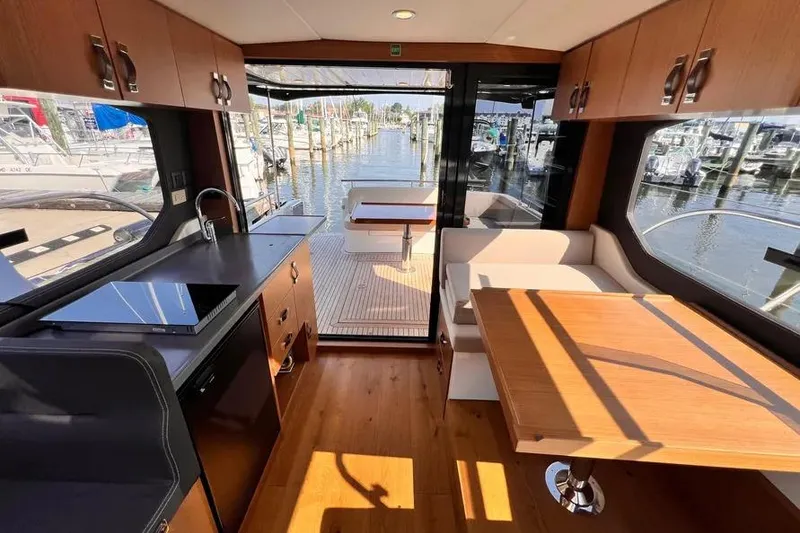 Slide: The Image of Modern interior of 2023 Pescador 35 yacht with kitchen and dining area, overlooking marina. - 12